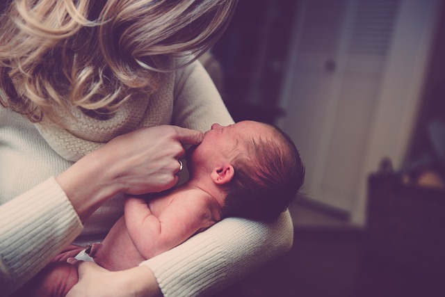 A parent holding a newborn baby