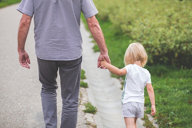 A father walking hand in hand with his child